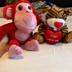 Tiger and monkey stuffed animals with heart